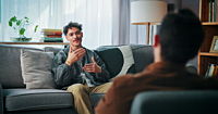 A man with psychologist in office for advice, help or life coaching session. Mental health, consulting and therapist with male patient for emotional support, wellness or talking.