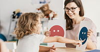 Emotion emoticons used by a psychologist during a therapy session with a child.