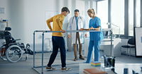 Strong Patient with Injury Making First Steps, Walks Holding for Parallel Bars.