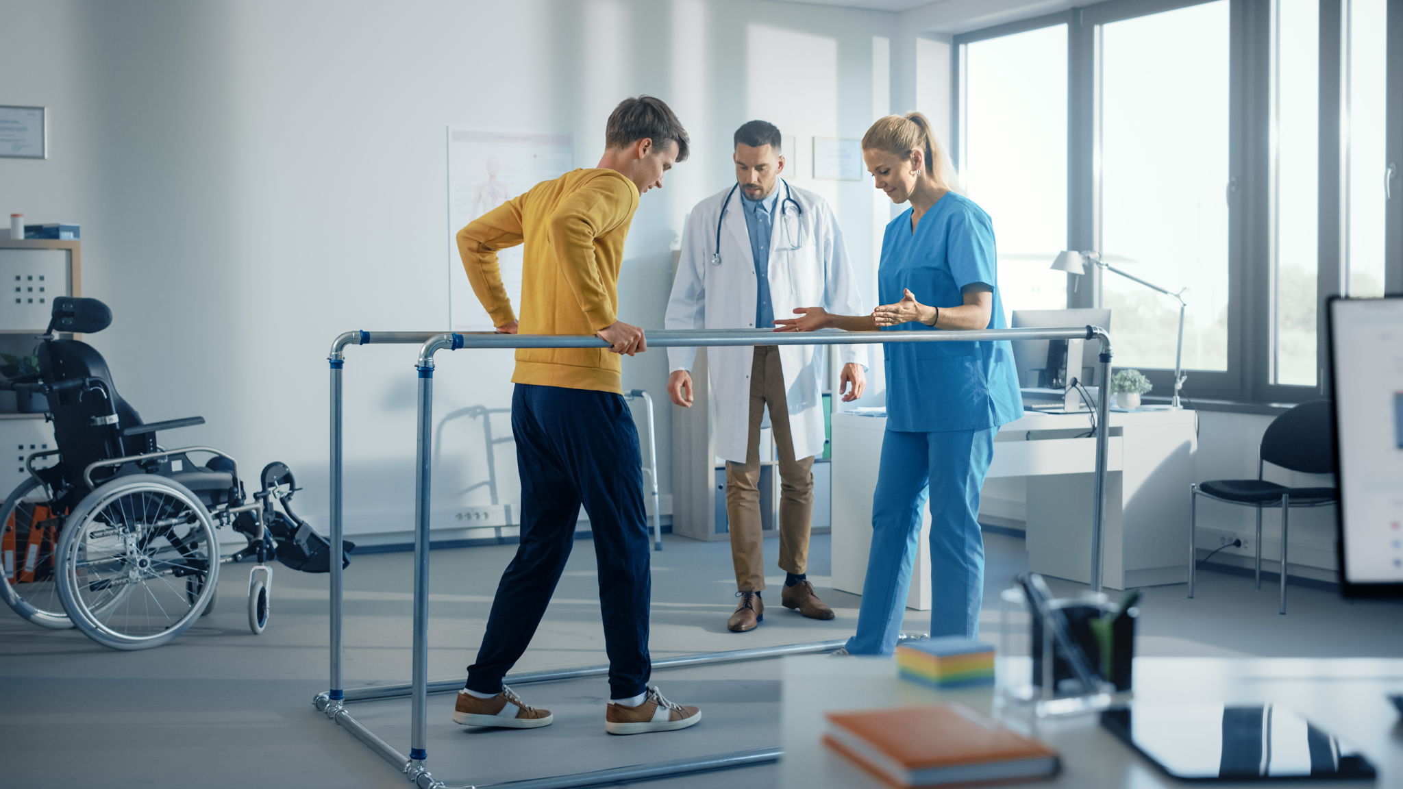 Strong Patient with Injury Making First Steps, Walks Holding for Parallel Bars.