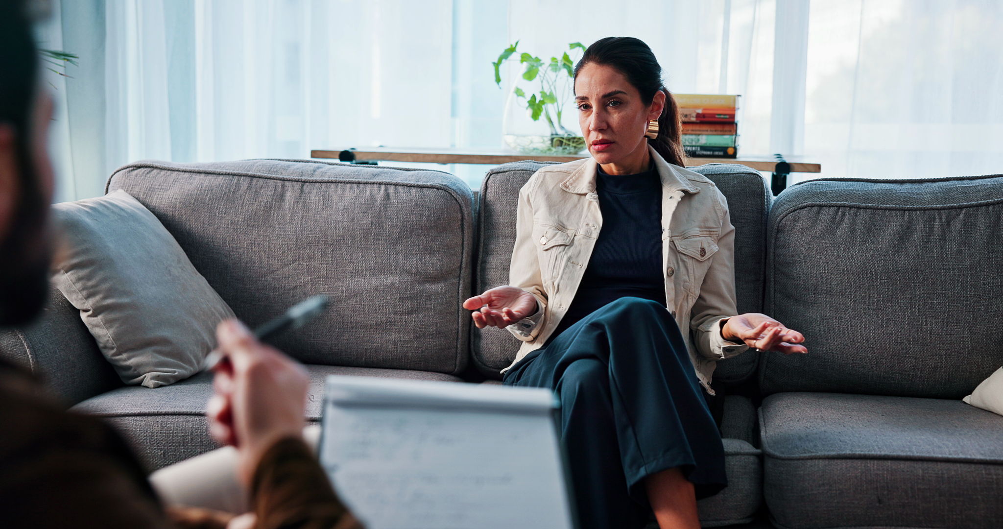 A woman receiving support from their therapist in an office setting.
