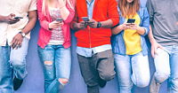 A group of adolescents using their phones