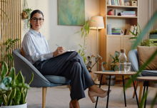 A therapist confidently sits alone in their office.