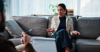 A woman receiving support from their therapist in an office setting.