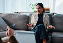 A woman receiving support from their therapist in an office setting.