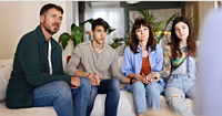 A worried family seeks help from a therapist in a private office setting.