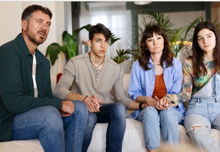 A worried family seeks help from a therapist in a private office setting.