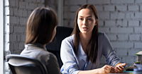 Experienced clinician counselor speaking with a new clinician