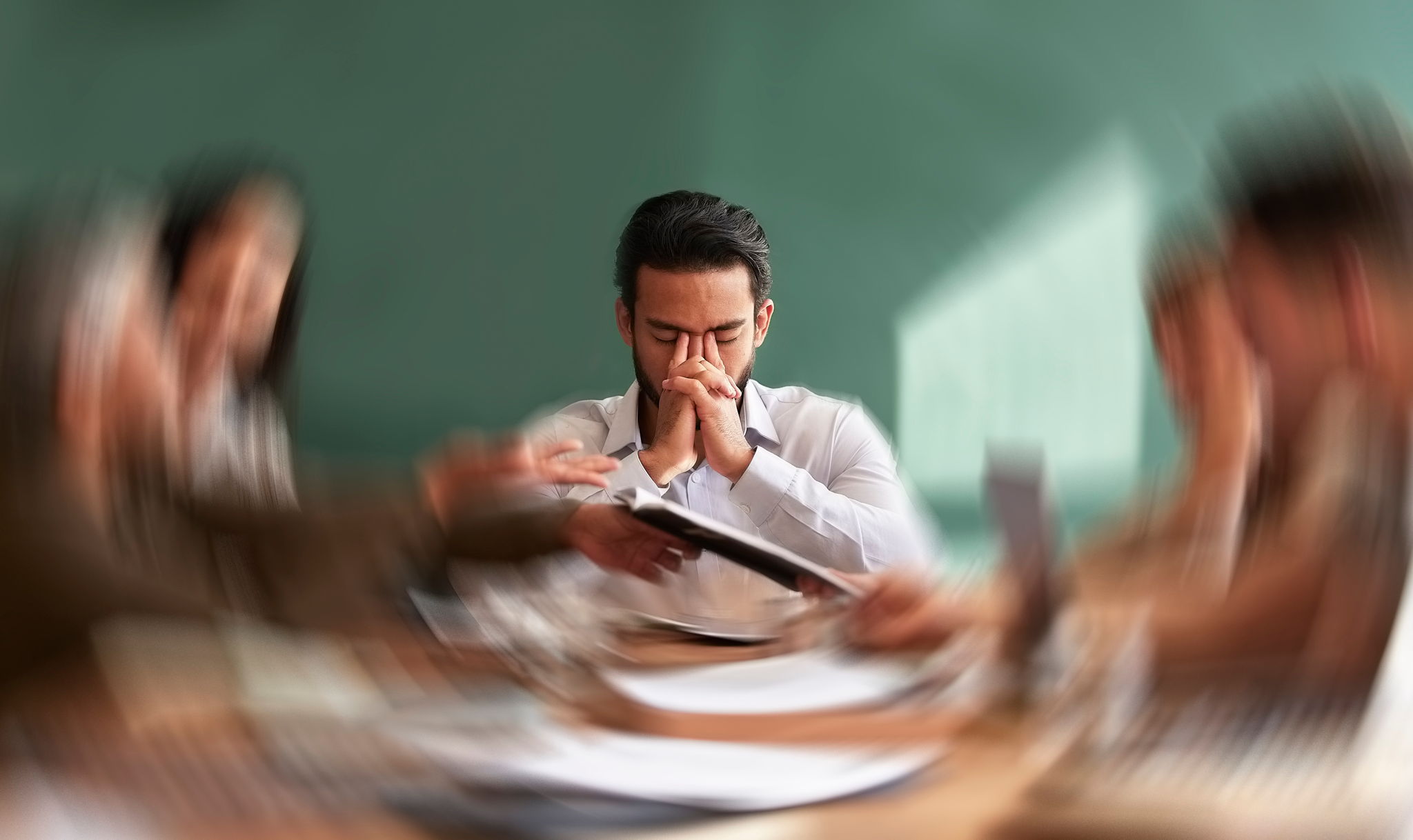 Stress, migraine and motion blur with a business man in a meeting feeling frustrated