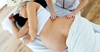 A pregnant woman having a massage.