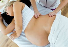 A pregnant woman having a massage.